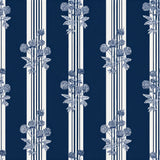 Midnight Calder wallpaper with blue and white stripes, patterned with blue floral sprays.