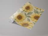 Rolled wallpaper with a sunflower pattern on a beige background.
