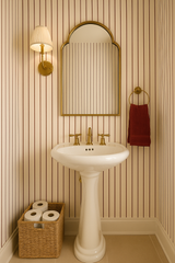 Oxblood stripe wallpaper with vertical, repeating pattern, seen in a traditionally styled bathroom setting.