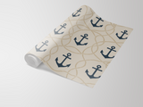 Anchor patterned wallpaper by York Wallcoverings with an anchor and rope design in navy and beige.