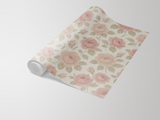 Bloomfield wallpaper with a rose floral pattern, rolled up on a white surface.