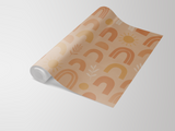 Beige boho wallpaper with earthy abstract pattern by Boho Bliss, shown in roll form.