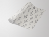 Botanical linework wallpaper with floral sprig pattern on a partially unrolled roll.