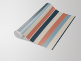 Cabana Revival wallpaper with retro stripes from York Wallcoverings, shown in a roll.