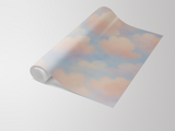 Cloudscape wallpaper with cloudy sky pattern by with peach and blue hues.