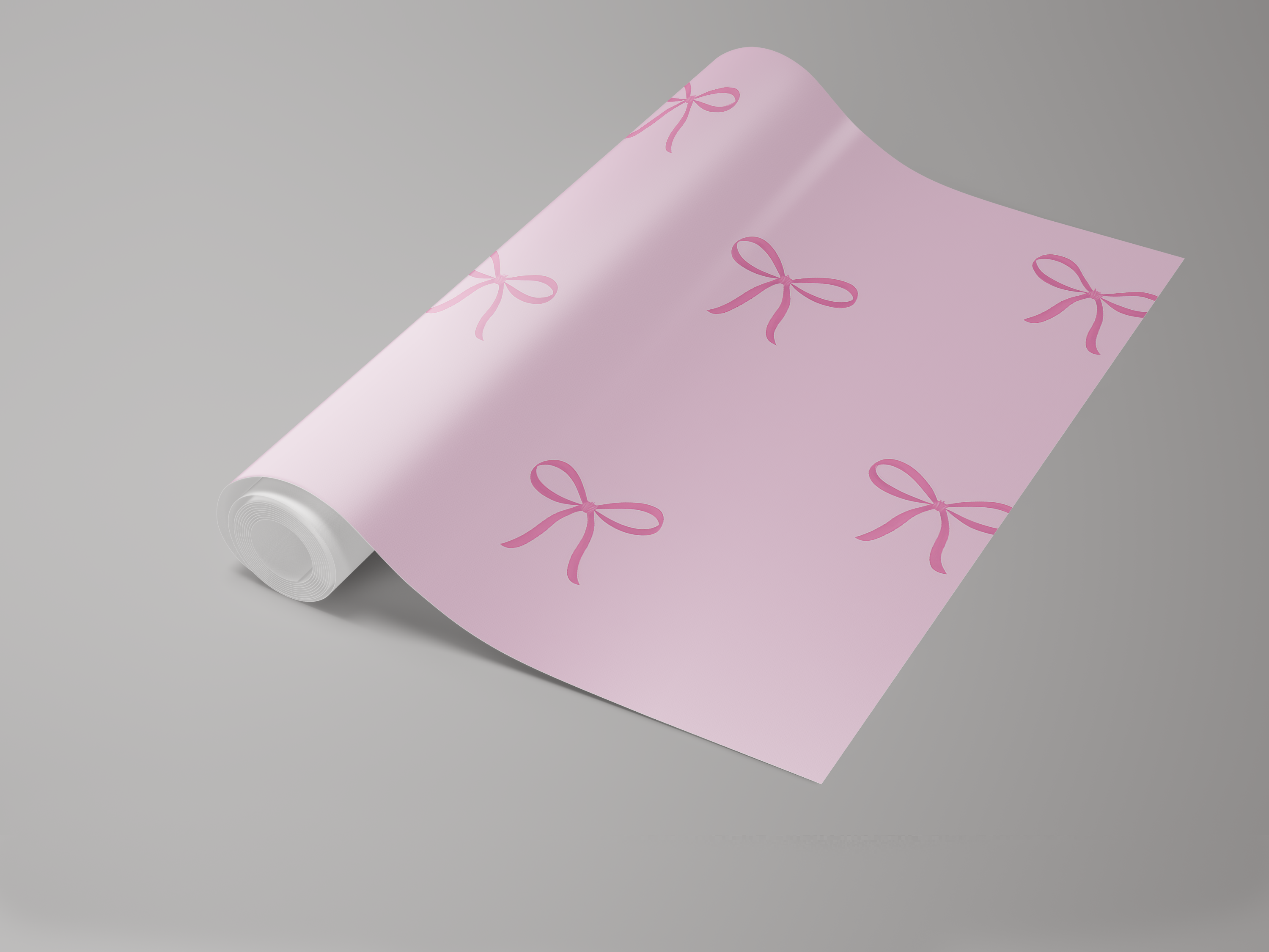 Light pink wallpaper with bow pattern by Wallpapers, featuring a roll format on a gray surface.