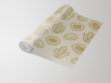 Neutral-colored wallpaper with crystal and geode pattern by, unrolled on a white surface.