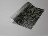 Roll of Deco Dawn wallpaper from Galerie, featuring a geometric art deco pattern with golden arches on a dark background.
