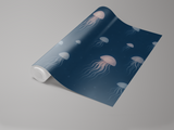 Dark blue Moonlit Drifters Wallpaper with jellyfish pattern on a roll.