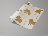 Cow-themed wallpaper with floral accents on a roll.