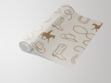 Beige Prairie Rider Wallpaper with western-inspired motif of cowboy hats, horseshoes, ropes, cowboy boots and riders on horseback.