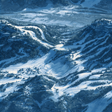 Blue wallpaper with snow-covered mountains and forests.