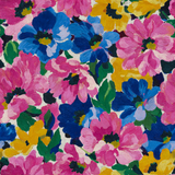 Floral wallpaper with a painterly finish, filled with pink, yellow, and blue blooms and green leaves.
