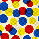 Polychrome pop wallpaper with overlapping red, blue, and yellow polka dots and a textured finish.
