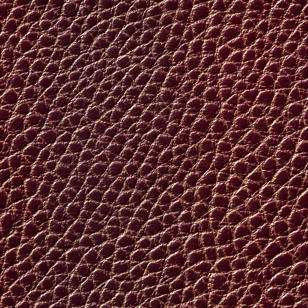 Oxblood wallpaper with leather texture, close-up.
