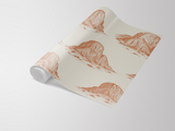 Beige Zion Hike Wallpaper with sketches by Seabrook Designs, rolled up on a white surface.